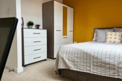 A bright and inviting double bedroom featuring ...