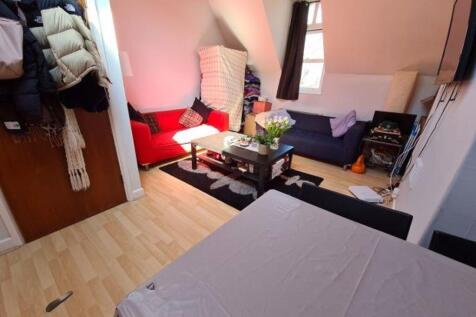 A cozy living room featuring a red sofa, coffee...