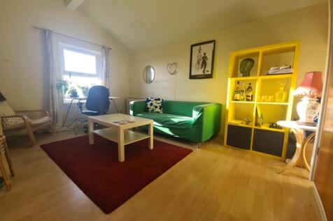 A bright and welcoming living room featuring a ...