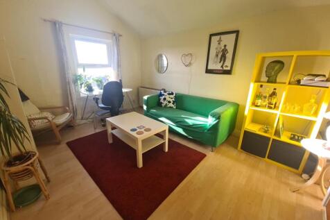 A bright and welcoming living room featuring a ...