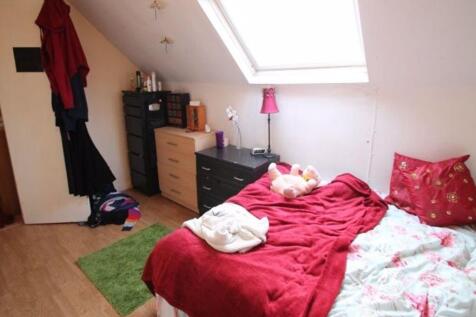 A bright, cozy bedroom with a skylight allowing...