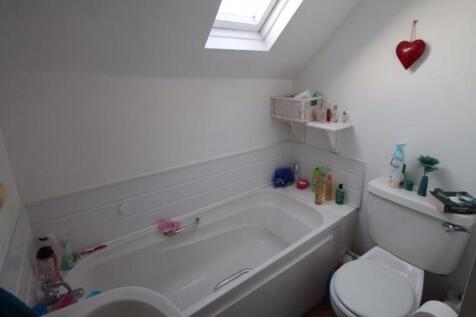 A well-maintained bathroom featuring a bathtub ...