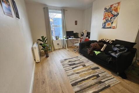 A bright and inviting living room featuring a c...