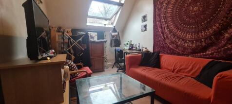 A cozy, well-lit living room featuring a comfor...