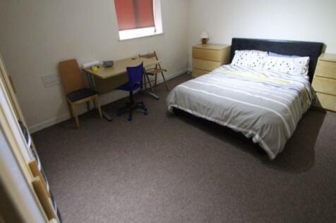 A cozy single bedroom featuring a comfortable b...