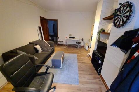 Spacious and inviting living room featuring com...