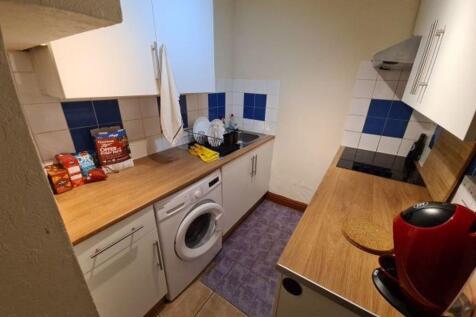 A compact, tidy kitchen area featuring essentia...