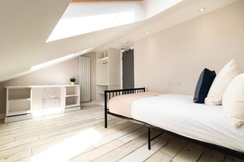 Bright and spacious master bedroom featuring a ...