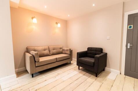 A spacious and well-lit contemporary living roo...