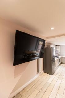 Modern kitchen area featuring a stainless steel...