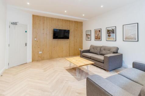 Bright modern living room with pale herringbone...