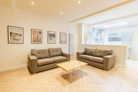 Bright, modern open-plan living area with two c...