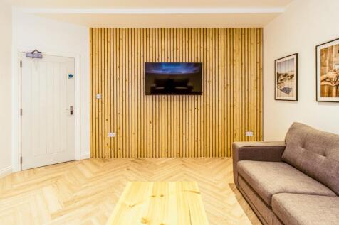 Contemporary living area with a feature slatted...