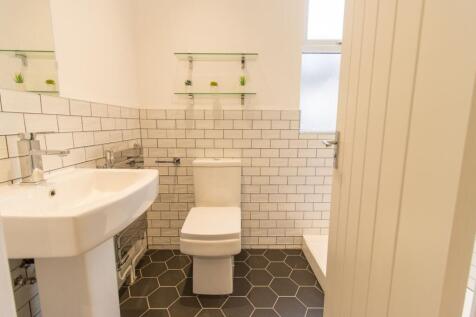 Bright, modern bathroom with white subway tiles...