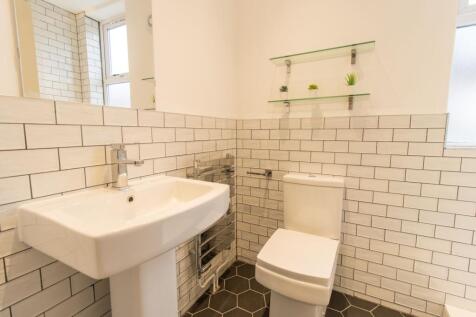Bright, modern bathroom with white subway tile ...