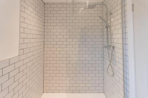 Modern tiled wet-room style shower with subway ...