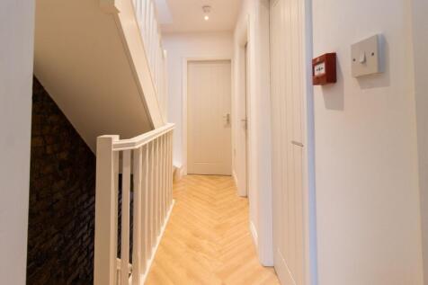 Bright, freshly painted upstairs hallway with l...