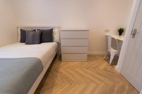 Bright, neatly styled bedroom with a double bed...