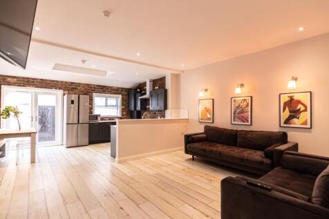 Bright, modern open-plan living area with expos...