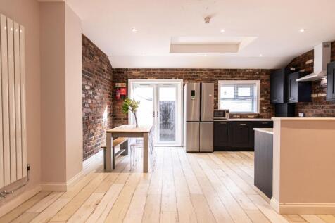 Bright open-plan kitchen and dining area with e...
