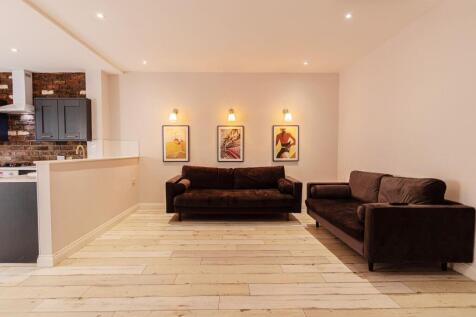 Bright, modern open-plan living area with two c...