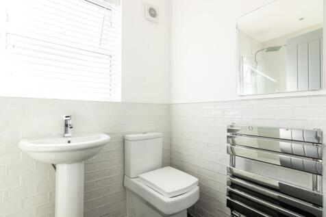 Bright, modern bathroom with white subway tiles...