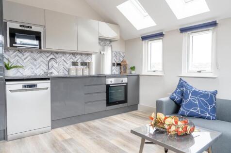 Bright and modern kitchen with ample natural li...