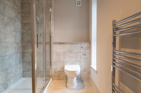 Bright and modern bathroom featuring a spacious...