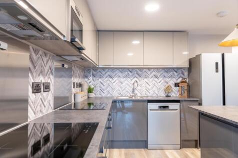 Modern and stylish kitchen featuring sleek cabi...