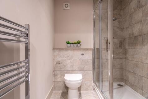 A modern bathroom featuring a shower enclosure ...