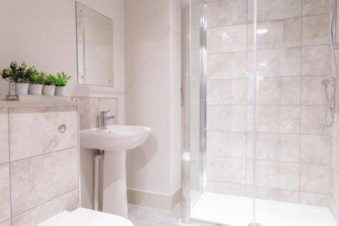Bright and clean bathroom featuring a modern sh...