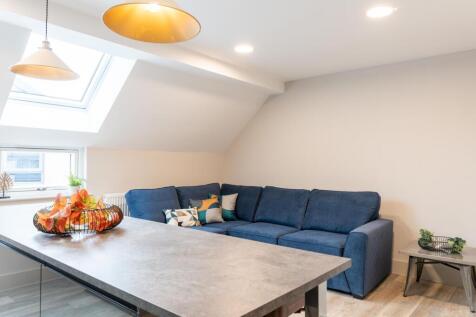 A spacious and modern living room featuring a l...