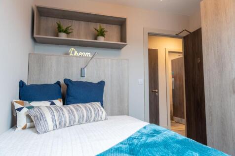 A modern and inviting master bedroom featuring ...