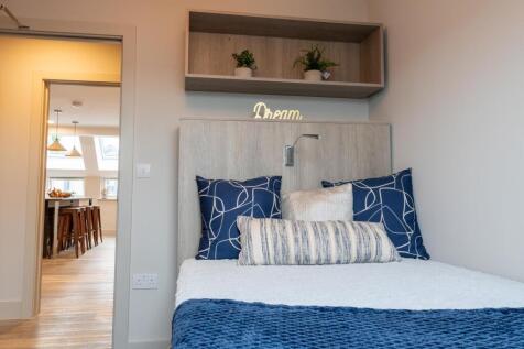 A well-decorated bedroom featuring a comfortabl...