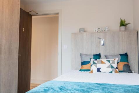 A bright and inviting double bedroom with moder...