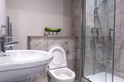 Modern bathroom featuring a shower enclosure wi...