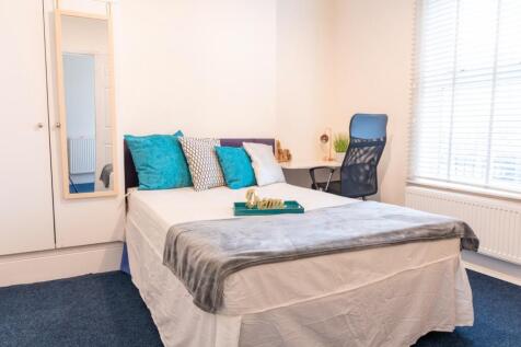 This inviting double bedroom features a comfort...