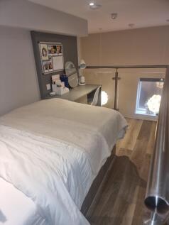 Cozy double bedroom featuring a comfortable bed...