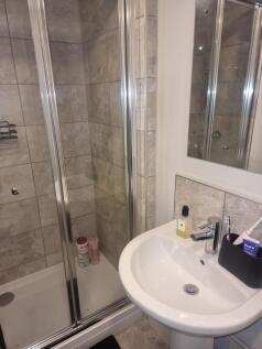A modern bathroom featuring a sleek shower encl...