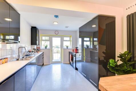 A modern and inviting kitchen featuring sleek c...