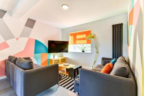 Bright and inviting living room featuring vibra...