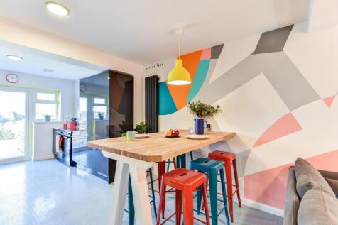 Bright and modern kitchen space featuring color...