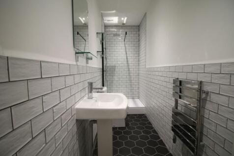 Contemporary tiled bathroom with a walk-in show...