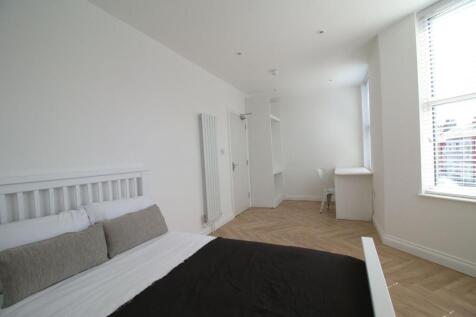 Bright, contemporary bedroom with a large windo...