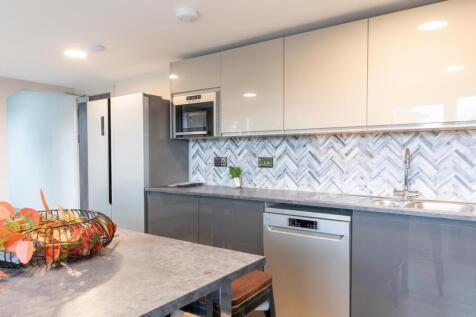 A modern and stylish kitchenette featuring slee...
