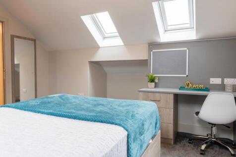 A bright and inviting double bedroom featuring ...