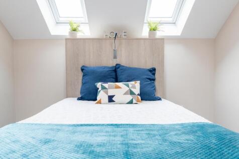 A bright and inviting double bedroom featuring ...