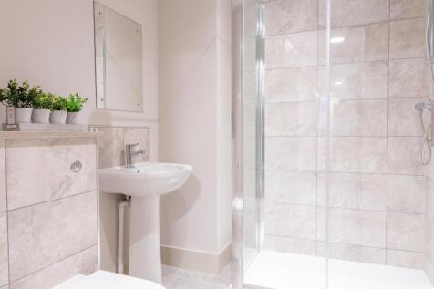 A modern and pristine bathroom featuring a styl...