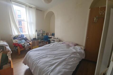 A cozy bedroom featuring a single bed, a wardro...
