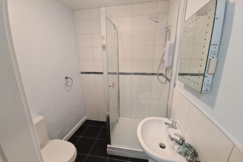 A clean and modern bathroom with a walk-in show...